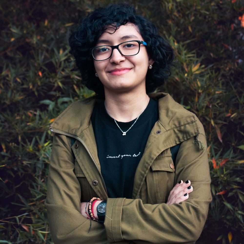 Photo by Alex McCarthy man in brown leather jacket smiling